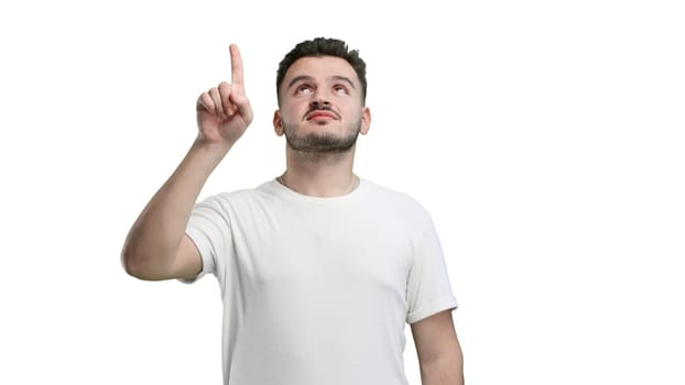 Man, close-up, on a white background, pointing up.