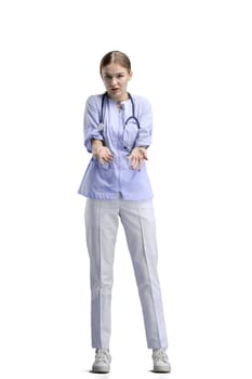 The doctor, in full height, on a white background, spreads her hands.