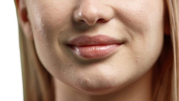 Woman's mouth, close-up, on a white background.