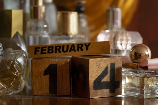 Valentine's Day represented through wooden cubes among perfume bottles