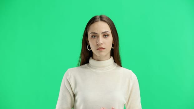 Woman, close-up, on a green background.