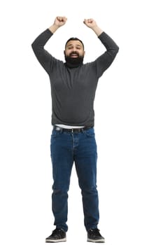 A man, full-length, on a white background, raised his hands up.