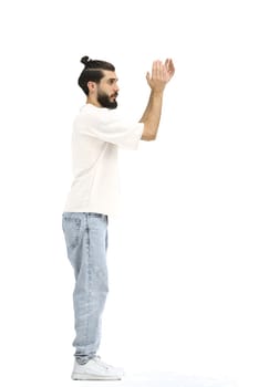 A man, full-length, on a white background, claps.