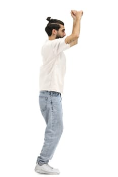 A man, full-length, on a white background, raised his hands up.
