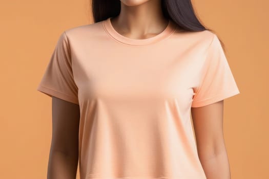 Woman in peach fuzz colored tshirt, can be used for design, mock up. The trending color of 2024