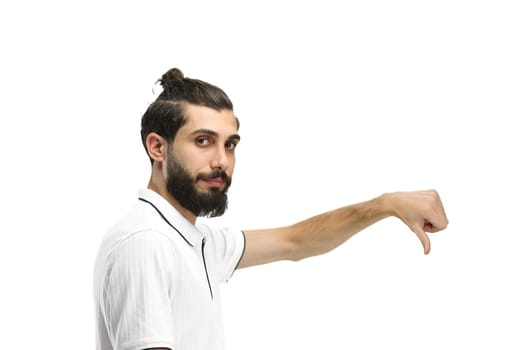 A man, close-up, on a white background, shows his thumbs down.