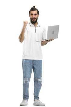 A man, full-length, on a white background, with a laptop.