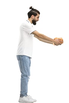 A man, full-length, on a white background, with a gift.