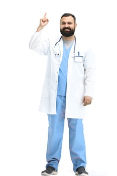 The male doctor, full-length, on a white background, pointing up.