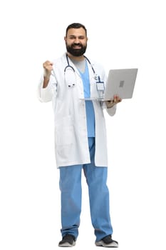 Male doctor, full-length, on a white background, with a laptop.