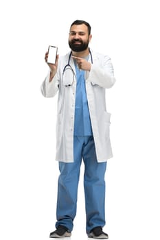 Male doctor, full-length, on a white background, with a phone.