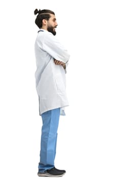 The male doctor, full-length, on a white background, crossed his arms.