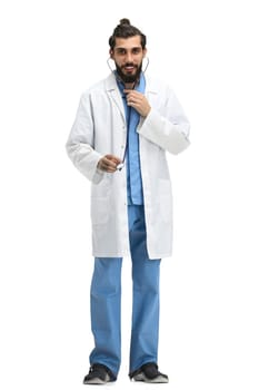 Male doctor, full-length, on a white background, with a stethoscope.