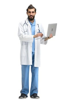 Male doctor, full-length, on a white background, with a laptop.