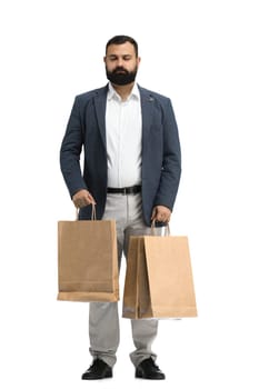 A man, full-length, on a white background, with bags.