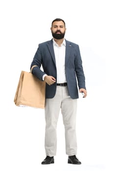 A man, full-length, on a white background, with bags and a phone.