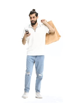 A man, full-length, on a white background, with bags and a phone.