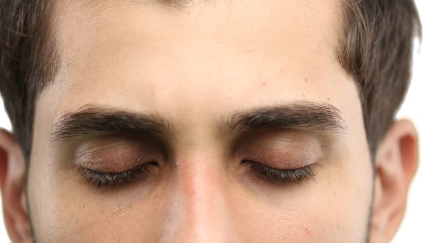 Man's eyes, close-up, on a white background.