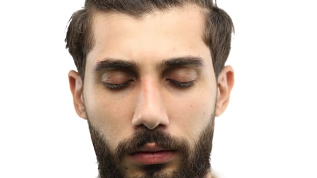 Man's face, close-up, on a white background.