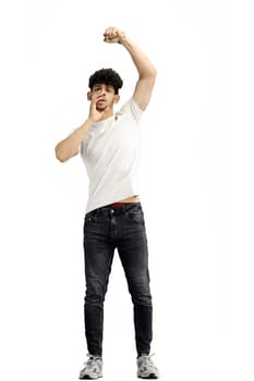 A man, on a white background, in full height, rejoices.