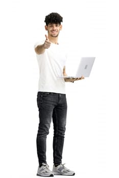A man, on a white background, in full height, with laptop.