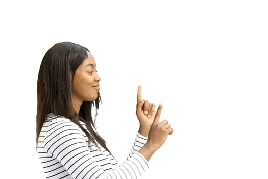 A woman, on a white background, in close-up, points to the side.