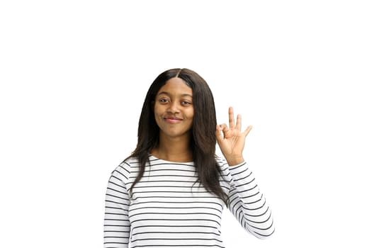 A woman, on a white background, in close-up, shows an ok sign.