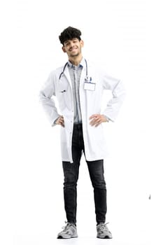 Male doctor, full-length, on a white background, hands on hips.