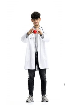 Male doctor, full-length, on a white background, shows a heart.