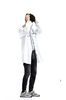 The male doctor, in full height, on a white background, clutched his head.