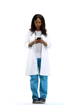 Female doctor, full-length, on a white background, with a phone.
