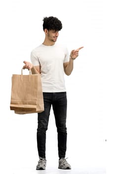 Man, on a white background, full-length, with bags, pointing to the side.