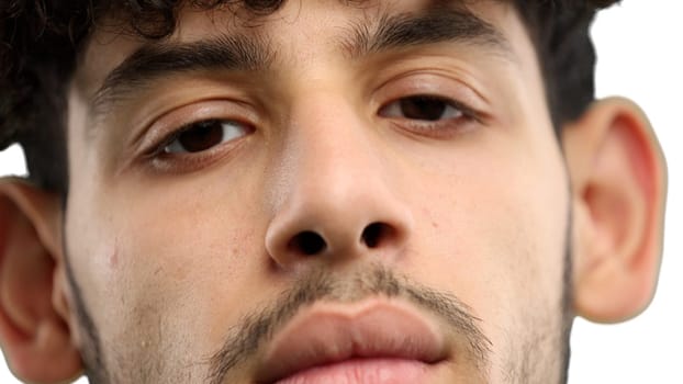 Man's face, on a white background, close-up.