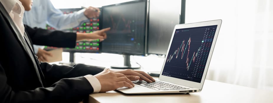 Cropped image of group of expert professional treader discuss about stock market graph show increasing graph while point on the computer display at office. Money exchange, growth chart. Burgeoning.