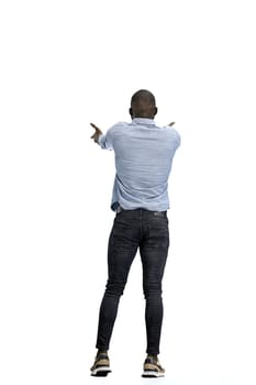 A man, full-length, on a white background, spreads his arms.