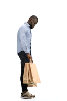 A man, full-length, on a white background, with bags.