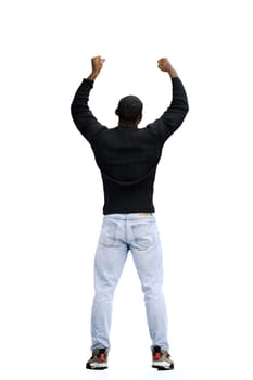A man, full-length, on a white background, raised his hands up.