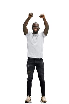 A man, full-length, on a white background, raised his hands up.