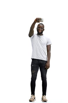 A man, full-length, on a white background, waving his phone.