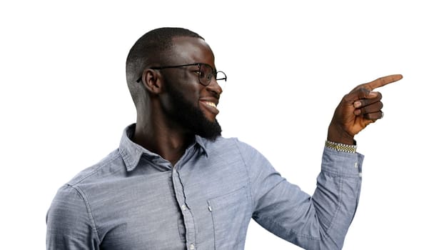 A man, close-up, on a white background, points to the side.