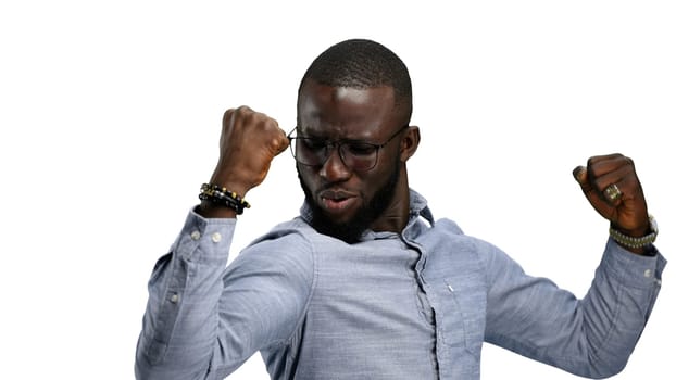 Man, close-up, on a white background, shows strength.