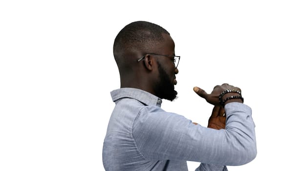 A man, close-up, on a white background, shows a pause sign.