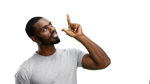 Man, close-up, on a white background, pointing up.