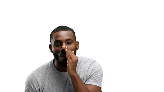 A man, close-up, on a white background, tells a secret.