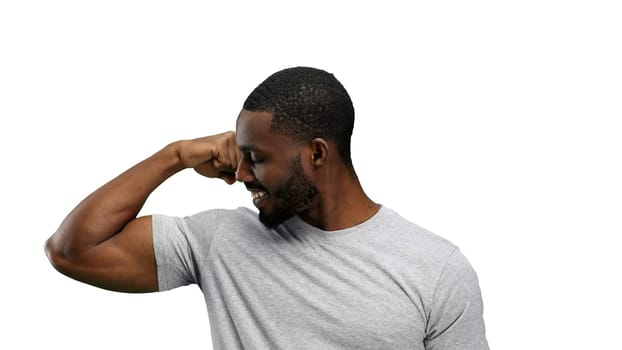 Man, close-up, on a white background, shows strength.