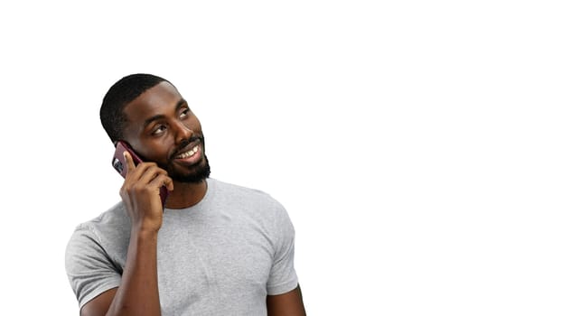 Man, close-up, on a white background, talking on the phone.