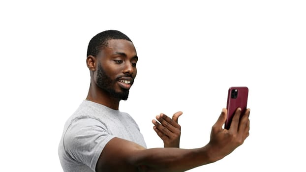 Man, close-up, on a white background, talking on the phone.