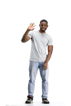 A man, full-length, on a white background, waving his hand.