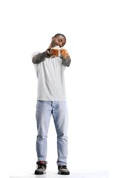 A man, full-length, on a white background, with a gift.