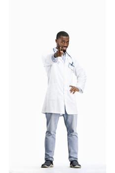 The doctor, in full height, on a white background, points forward.